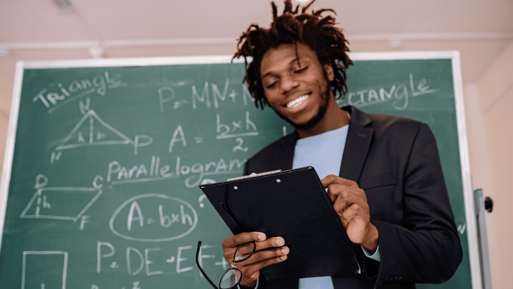 student in front of blackboard