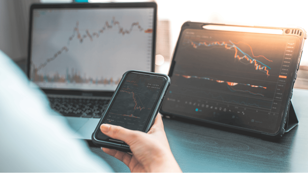 Stock market on laptop, tablet and phone