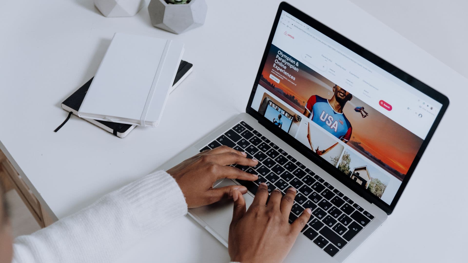 Person scrolling through Airbnb listings on computer