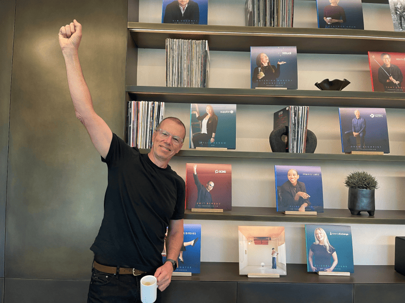 A photo of Gong CEO Amit Bendov smiling with his arm raised at Norwest headquarters