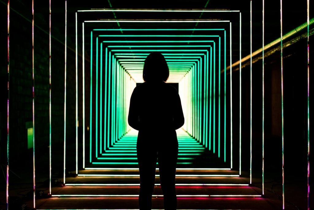 silhouette of woman in LED hallway