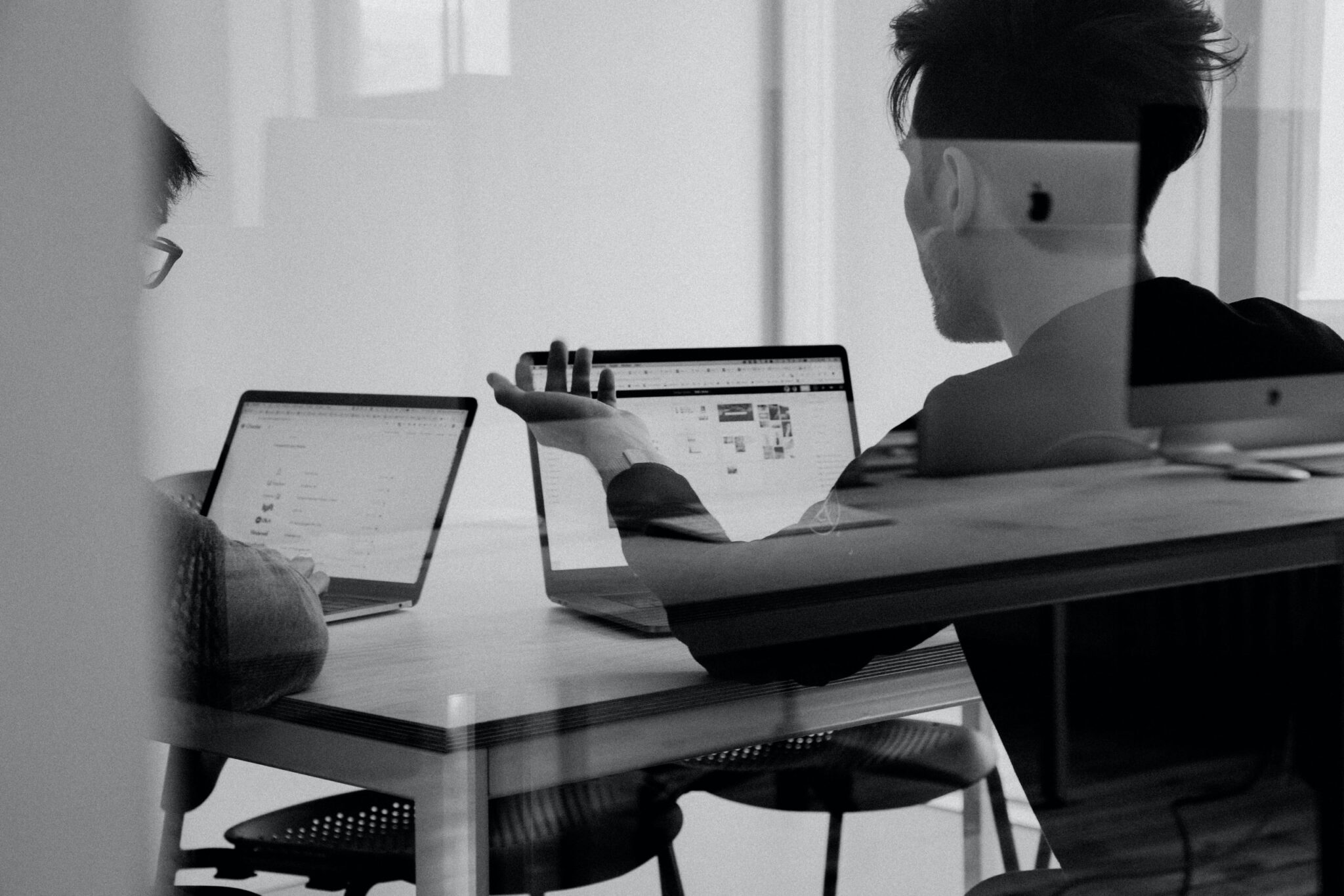 two people working with laptops