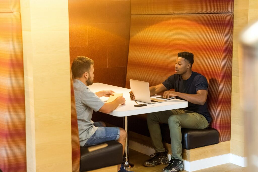 two men working in a booth