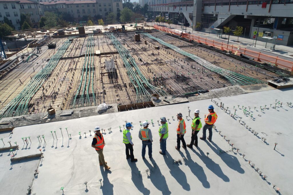 Construction workers in hard hats overseeing a construction site