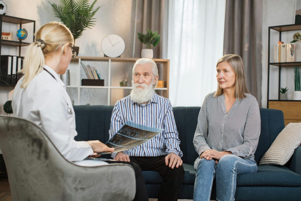 a retired couple sitting with a doctor