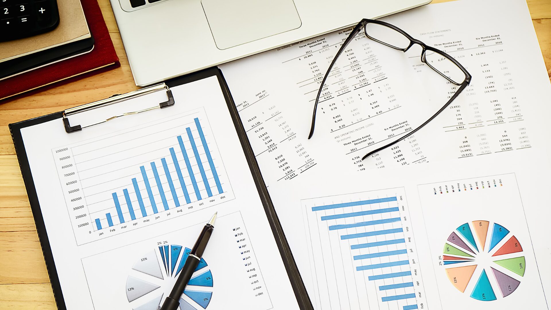overhead view of charts, graphs, and financial paperwork on a desk