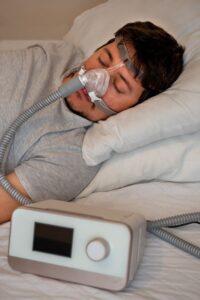 Man sleeping with CPAP machine